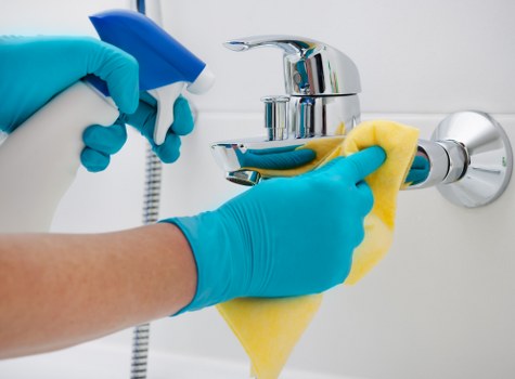 Cleaner maintaining a tidy Wimbledon living room